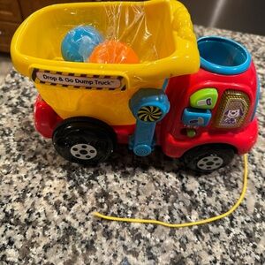 Vtech Colorful Drop & Go Dump Truck Toy with 2 rocks boulders